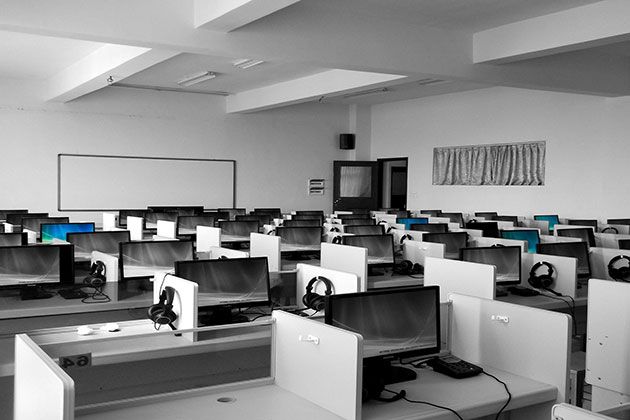 Empty call centre with rows of computer stations