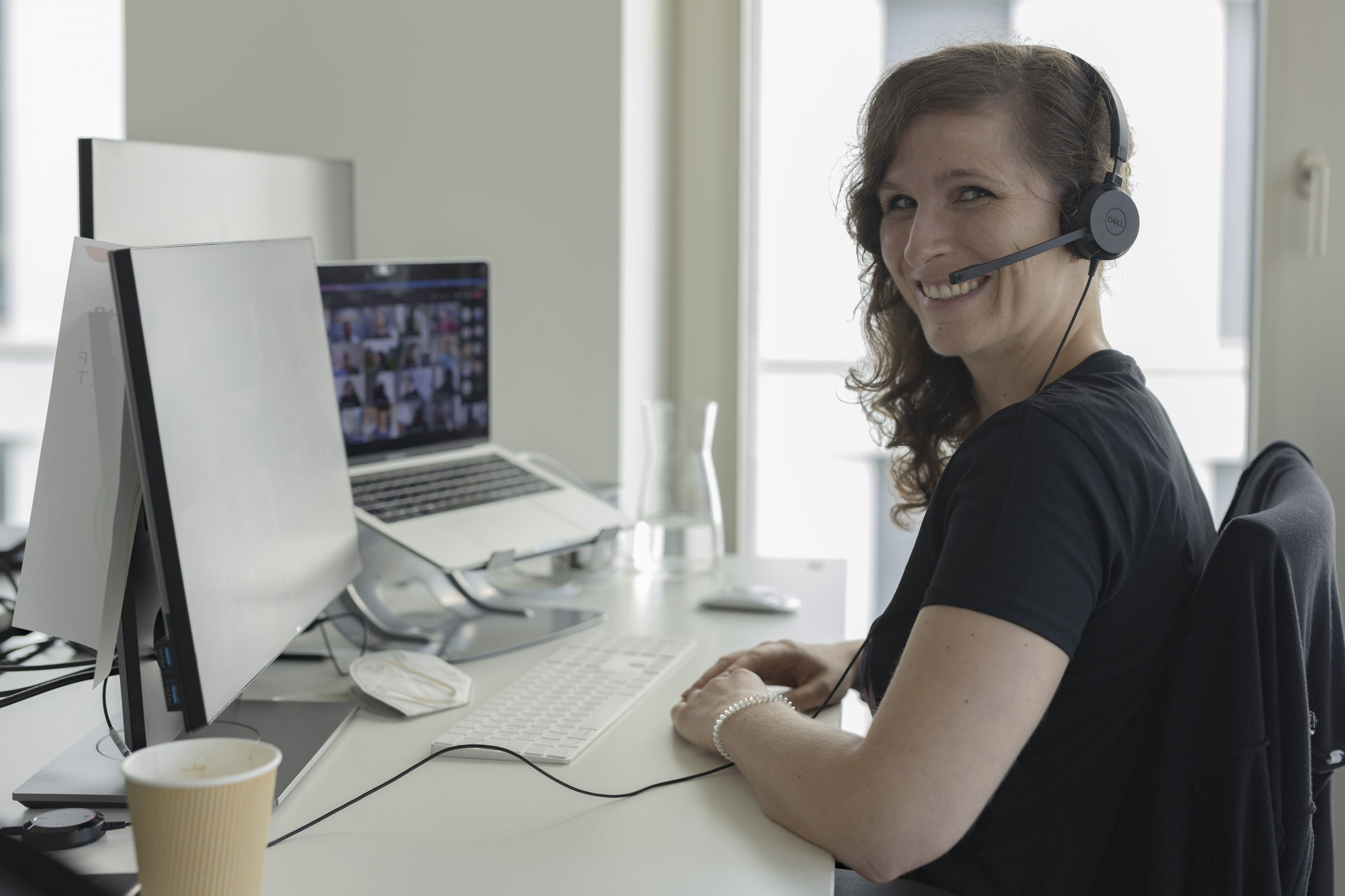 Woman with headset on laptop